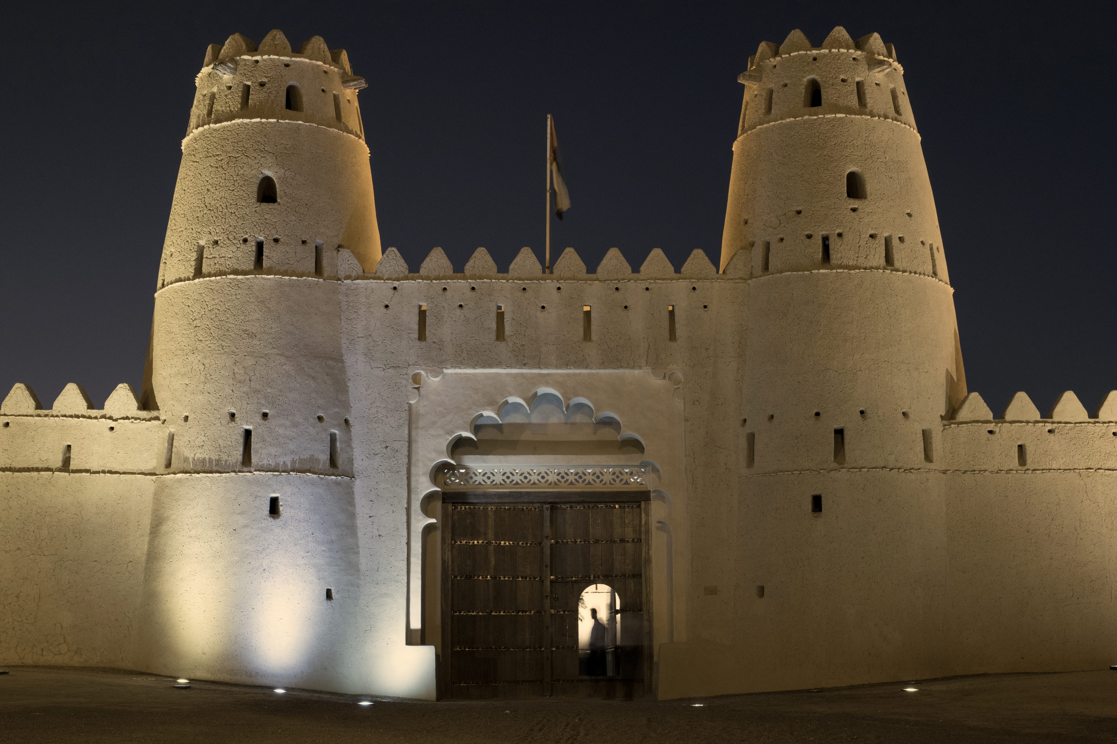 Al Jahili Fort in Al Ain, its twin towers lit against the night sky
